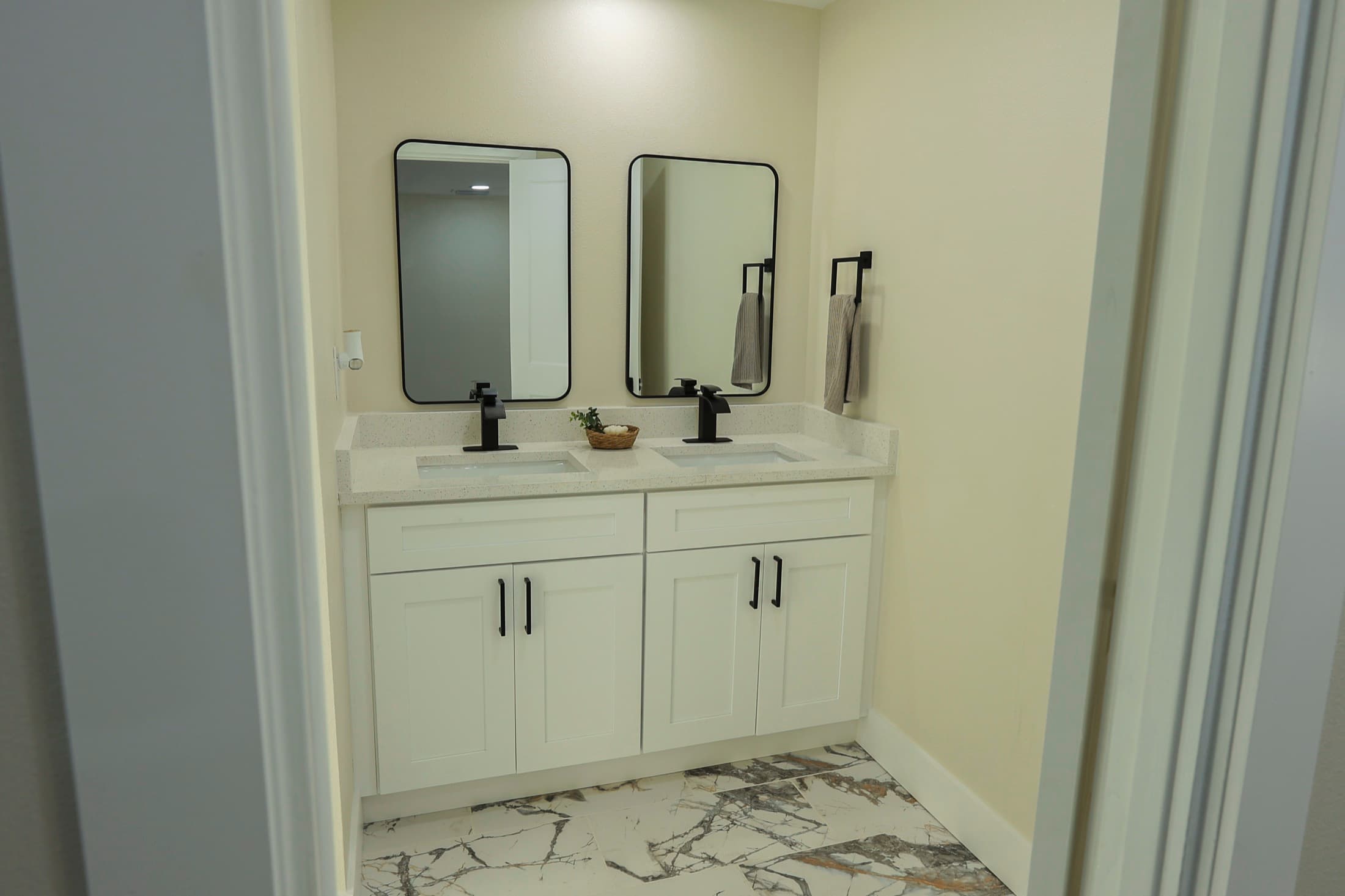 Double vanity bathroom with marble flooring